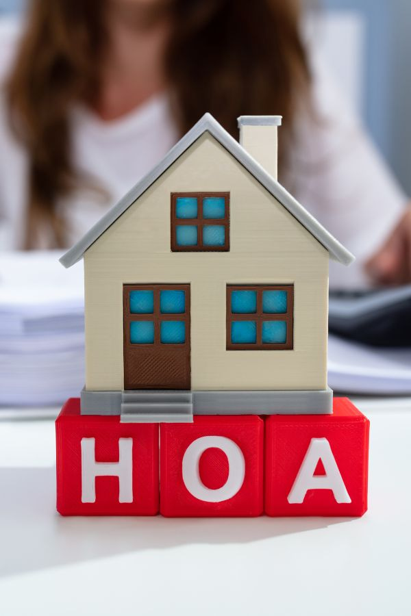 model of a home with the letters HOA underneath