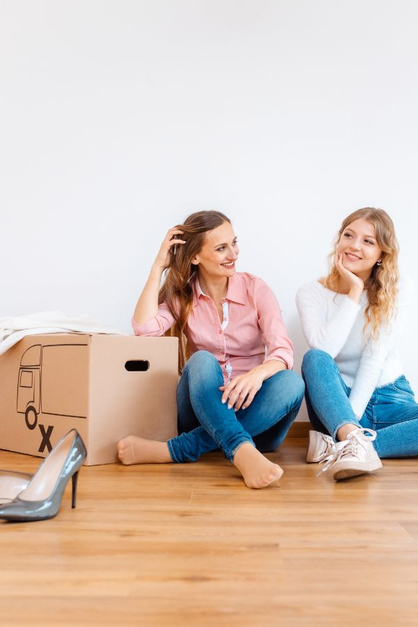 image of two women smiling while unpacking